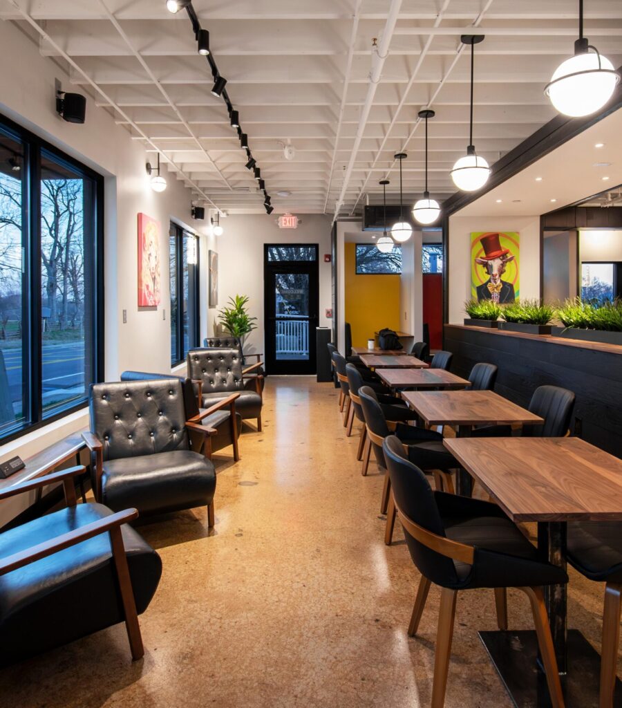 Interior of the coffee shop highlighting reclaimed materials and cozy seating areas.