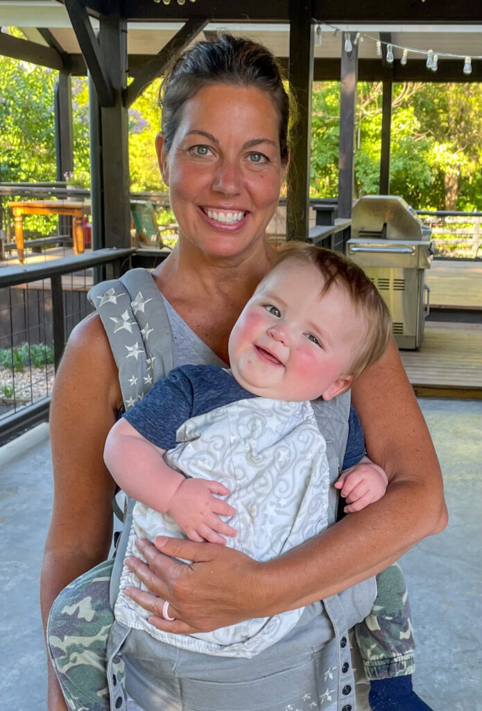 Jamie holding her grandchild.