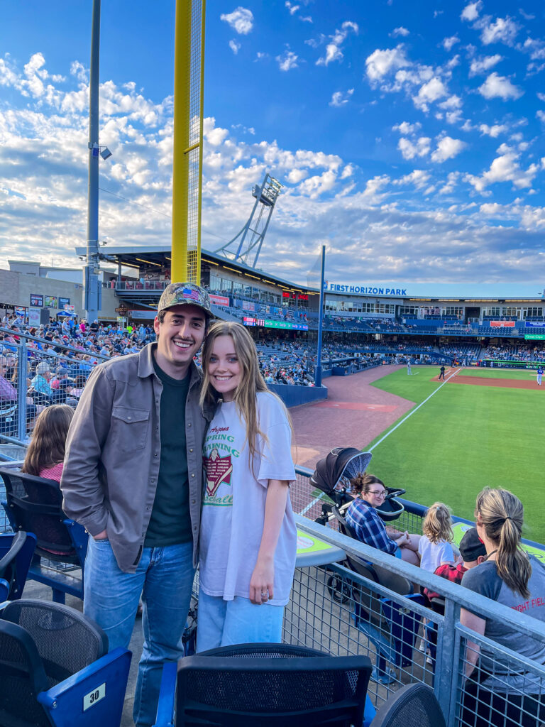 Team members posing in front of the baseball field in Nashville.