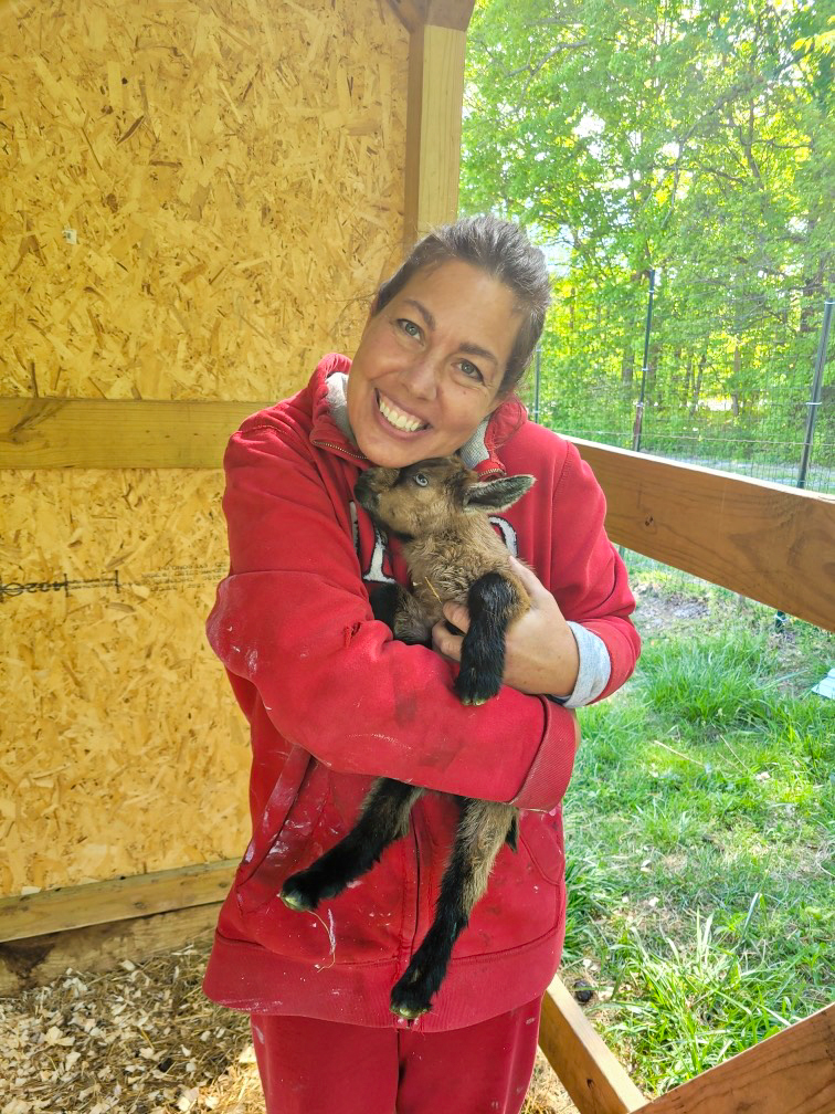 Jamie Pierce smiling on her 6-acre farm near Franklin, TN.